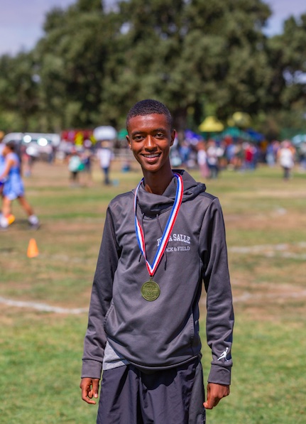 Trey Caldwell with the medal he won earlier this year at the Nike Invitational. (Image courtesy De La Salle cross country)