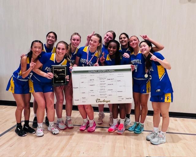 Foothill girls' basketball celebrates after winning the title of the Cowboy Winter Classic. (Photo by Sara Terpstra)